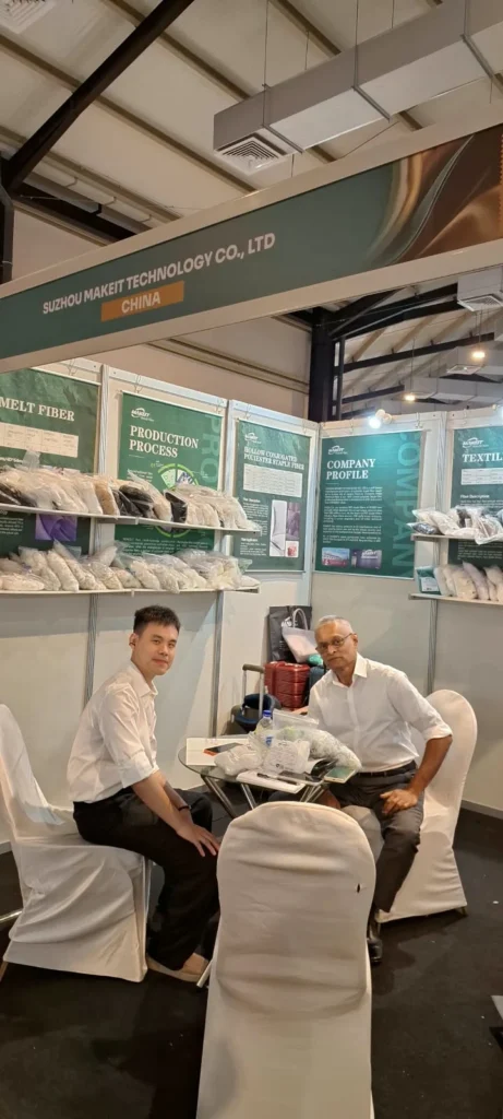 MAKEIT Fiber discussing polyester staple fiber solutions with a visitor at INTEX Sri Lanka 2026