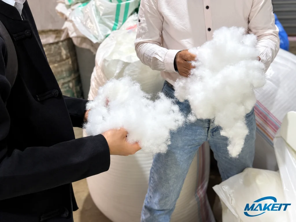 MAKEIT team examining fiber filling materials with a bedding customer in Cairo.